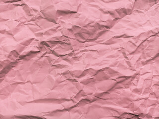 Fototapeta premium detailed close-up texture of a heavily crumpled and wrinkled sheet of pink paper, showing numerous creases, folds, and shaded lines across the surface.
