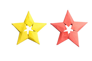 Fototapeta premium Yellow and red origami stars arranged together isolated on transparent background simple festive craft objects.