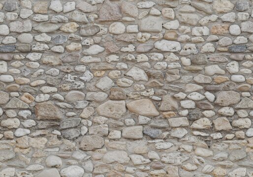 Seamless cobble stone wall texture background. Natural river stone masonry wall backdrop.