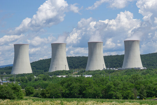 nuclear power plant background blue sky surface close up of cooling towers emitting steam industrial product concept of green energy, atomic station, electricity generation