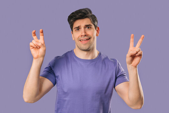 Skeptic young man With Hands Two Fingers Air Quotes On violet, Sarcasm,Cynicism