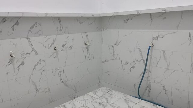 Modern mosque ablution area with elegant white marble walls