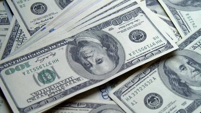 High-quality images reveal an abundant collection of hundred dollar bills, highlighting intricate designs and a sense of wealth in a rich setting