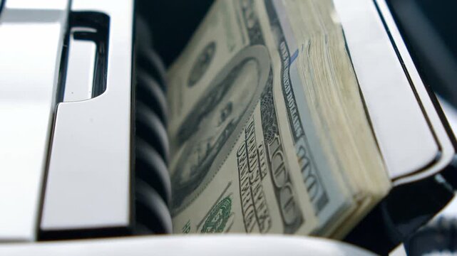 A machine processes stacks of cash rapidly, showing the beauty of currency production. Bright money reflects the hustle of a busy banking day filled with transactions