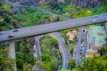 Obraz premium Madeira, Portugal, 30.05.2026: Highway Bridge and Tunnel Network Crossing a Mountain Valley Near Funchal
