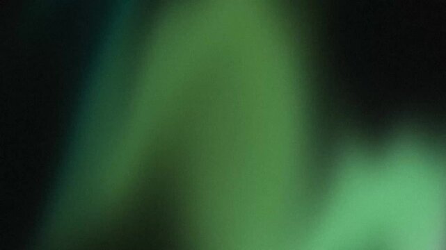 Emerald film grain texture shimmering in dark cinematic space creating gritty analog retro aesthetic