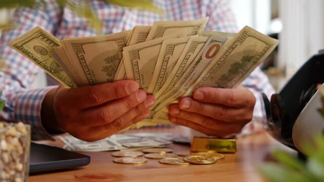 Hands sort through bills, counting cash with care at a busy cafe filled with sunlight. The energy of the afternoon wraps around moments of joy and wealth