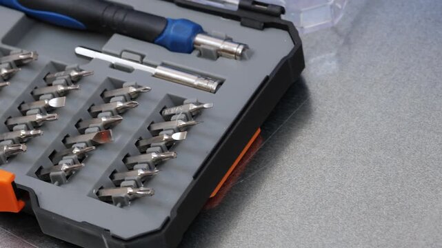 A set of metal bits for installation work in a plastic case.