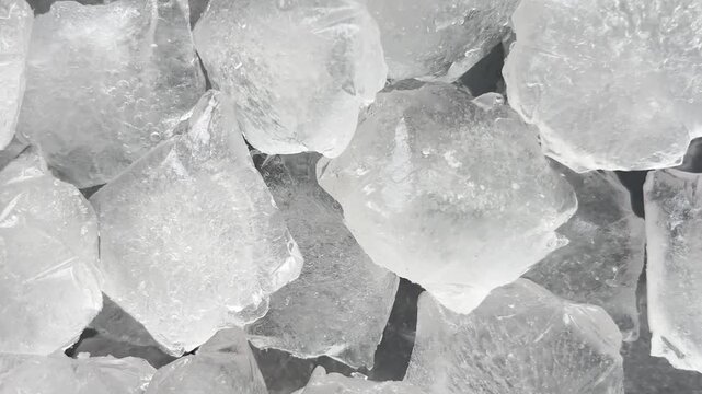 Camera flyover above large clear ice cubes macro texture