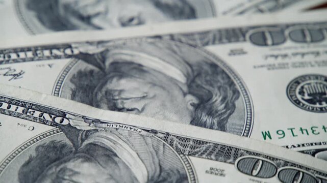 Delve into the intricate designs of one hundred dollar bills, showcasing the rich textures and fine details that often go unnoticed in everyday life