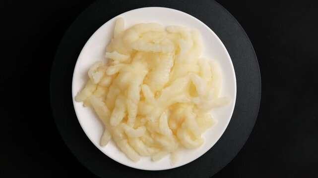Boneless Chicken Feet (Phoenix Claws) in white plate.Debone chicken feet.Top view.