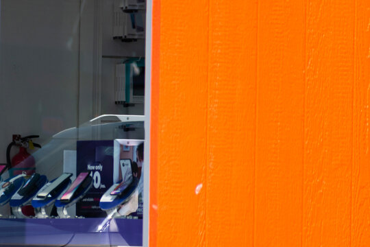 Several phones on display at a cellular phone store.