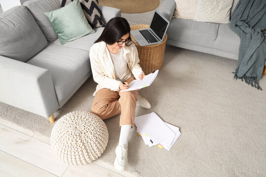 Female screenwriter writing script in office, top view