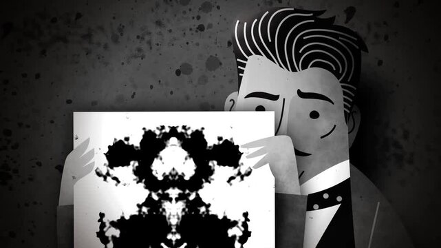 vintage black and white psychiatrist holding a rorschach test