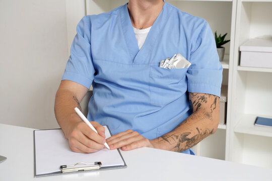 Young doctor with condoms in pocket in clinic