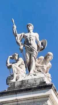 Victor Emmanuel II monument in Rome showing white marble architecture, bronze quadriga, equestrian statue, marble relief sculptures, Italian flags waving, decorative fountains, an