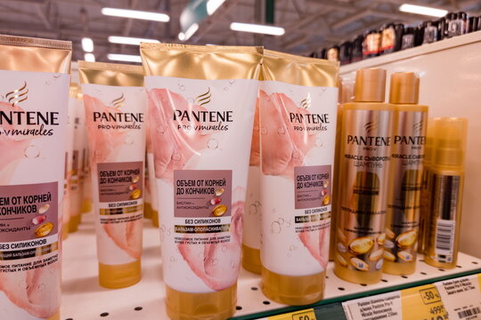 Collection of Pantene Pro-V Miracles hair care products displayed on a store shelf, including volumizing shampoo and protective sprays specially formulated to boost hair from roots to ends without sil