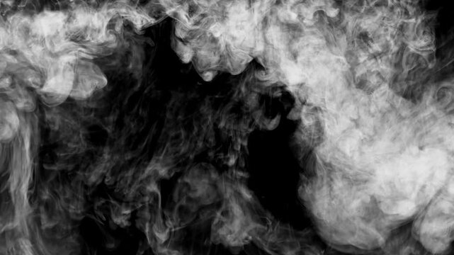 An abstract, slow-motion video showing black ink dropping from the top edge and gracefully dissolving into water against a clean white background. The ink forms dense, fluid textures expands downwards