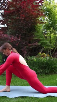 Vertical screen Woman holds deep lunge yoga pose outdoors representing commitment to change rebuilding body confidence and choosing healthy habits over quick fixes before summer