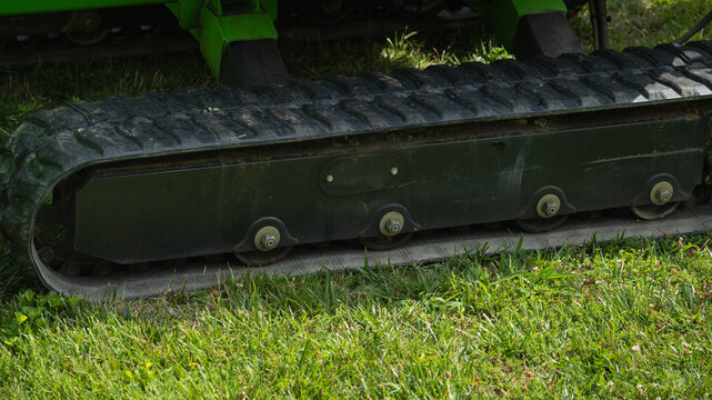 Close-up, side view of track system on a piece of construction equipment.