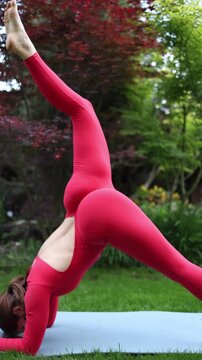 Vertical screen Woman performs intense inversion yoga pose outdoors reflecting discipline body control and the pressure to push limits in pursuit of ideal shape and self mastery