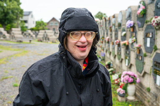 Woman mourning at grave in Tienen cemetery