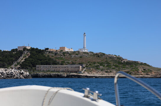 Faro di Santa Maria di Leuca lighthouse seen from a boat cruising along the coast of Puglia, Italy