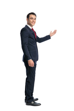 Side view of elegant man presenting and smiling