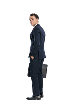 Side view of confident man looking over shoulder holding briefcase