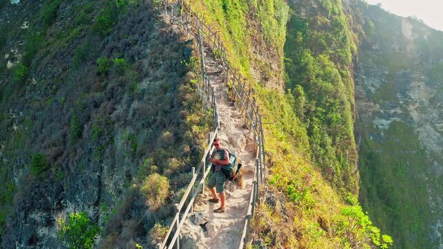 Travel people enjoy amazing view famous landmark and popular travel destination Kelingking beach Nusa Penida, Bali, Indonesia 4K