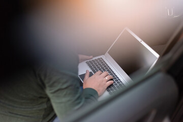 Fototapeta premium Digital Nomad Working on Laptop in Vehicle During Evening Travel Stop