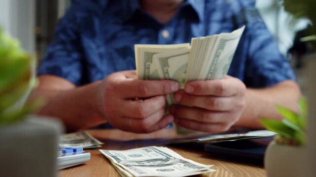 A man sits at a wooden table in his cozy home, carefully counting stacks of dollar bills as sunlight streams through the window, creating a serene atmosphere
