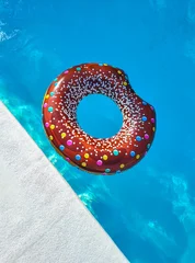 swimming pool ring float in blue water and sky sunlight reflection, holiday and vacation, summer background, top view copy space © x.marynka