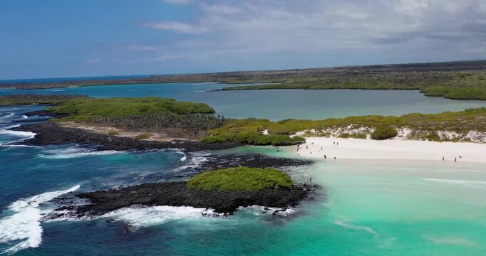 Aerial Drone Semicircle Movement Over Rocky Coast and Sandy Beach in Galapagos Islands