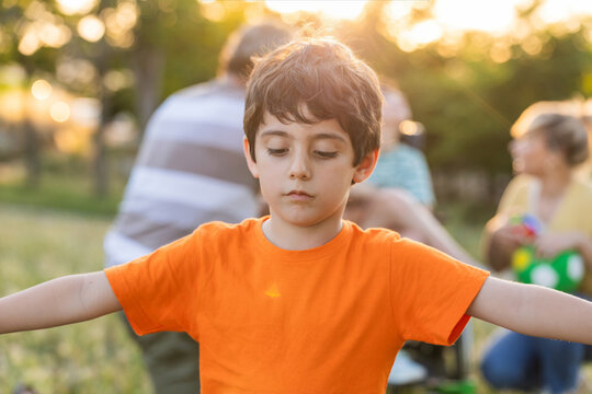 Sad child feeling excluded from family playing