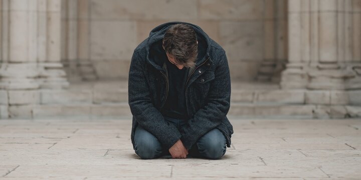 man kneeling and bowing to worship his god