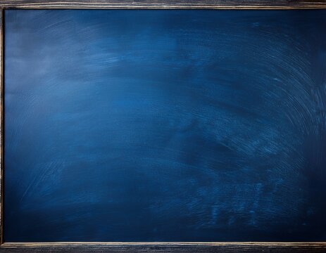a dark blue chalkboard with traces of erasing featuring a full surface frame and a textured background copy space image