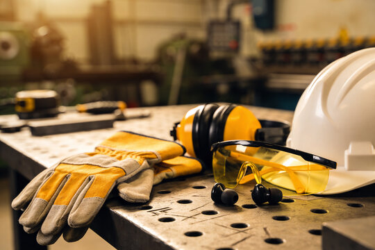 Essential personal protective equipment laid out on a workshop table for safety