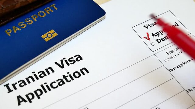 Hand marking an approved checkbox on an Iranian visa application form with a red pen, travel and immigration