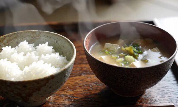 Traditional rice and miso soup served in ceramic bowls with gentle steam