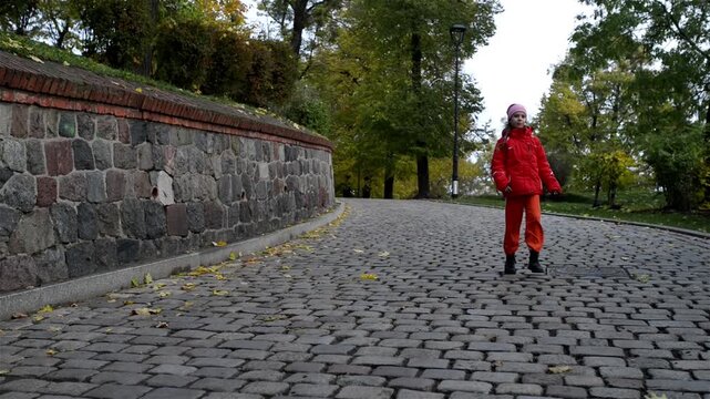 Little girl goes on cobbled pavement