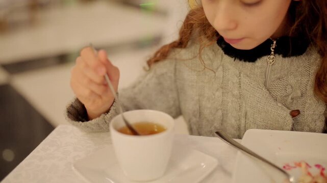 Little beautiful girl drinking tea