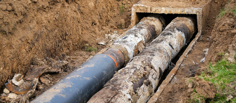 Emergency repair of district heating pipes in open excavation trench with replacement of damaged sections, accident elimination and utility infrastructure restoration
