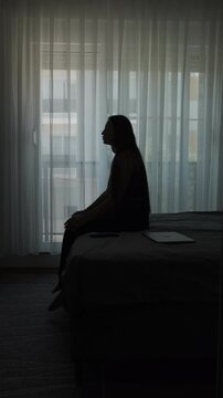 Digital nomad burnout and emotional fatigue concept, woman feeling disconnected from home after repeated relocation and temporary living, vertical
