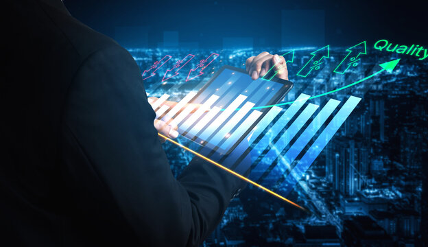 Business Executive Analyzing Growth Trends with Digital Tablet in a Modern Urban Setting During Night with Data Visualization Graphics. Bitwise.