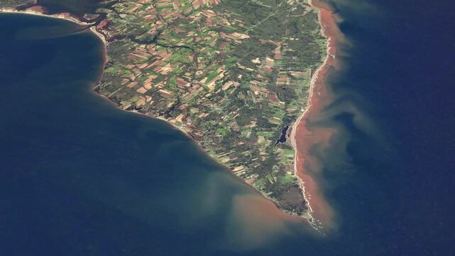 Flying over scenic Atlantic coastal peninsula with farmland and rugged shoreline satellite view from space based on Nasa imagery