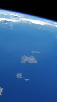 Vertical flying over Balearic Islands Mallorca Menorca Ibiza and Formentera with curved Earth horizon above the Mediterranean Sea satellite view from space based on Nasa imagery
