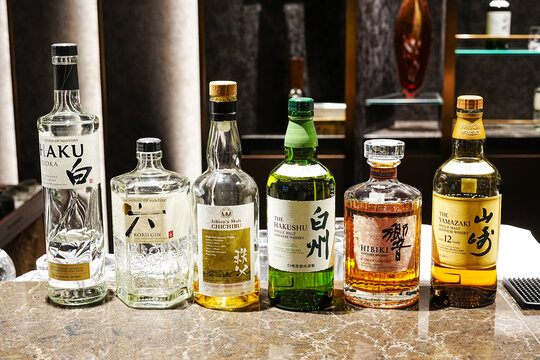 Tokyo, Japan - September 01, 2025: Bottles of Japanese spirits including Haku vodka, Roku gin, Ichiro&rsquo;s Malt Chichibu, Hakushu, Hibiki, and Yamazaki are displayed at a Japan Airlines Lounge bar