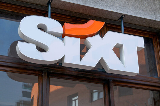 Sixt rent a car corporate logo sign on a traditional building facade in Switzerland