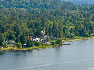 Obraz premium Waterfront Homes on a Forested Lake Shore Near Mission BC Canada, Scenic Riverside Neighborhood
